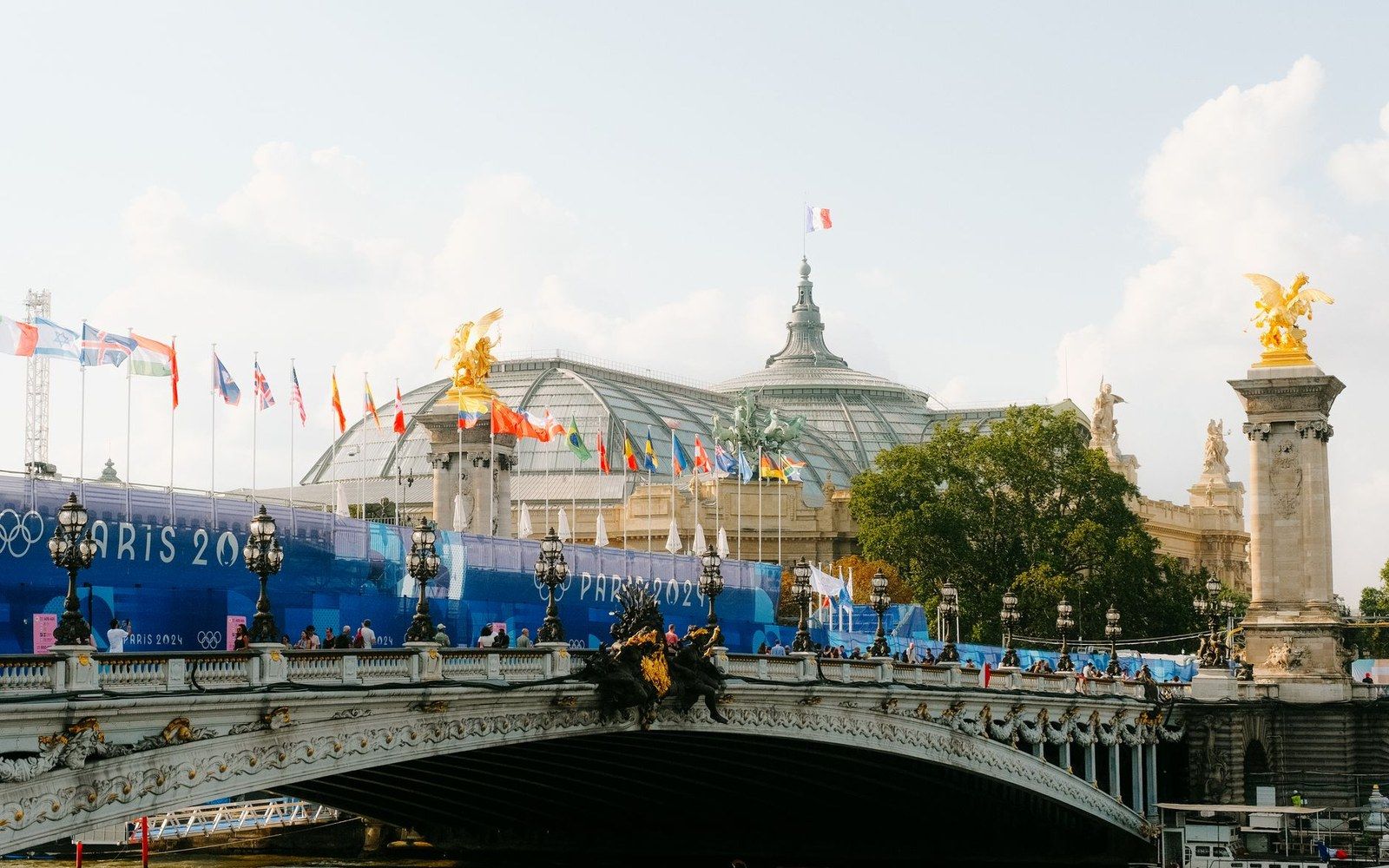 Pont Alexandre III bridge with Olympic banners in front of the Grand Palais dome